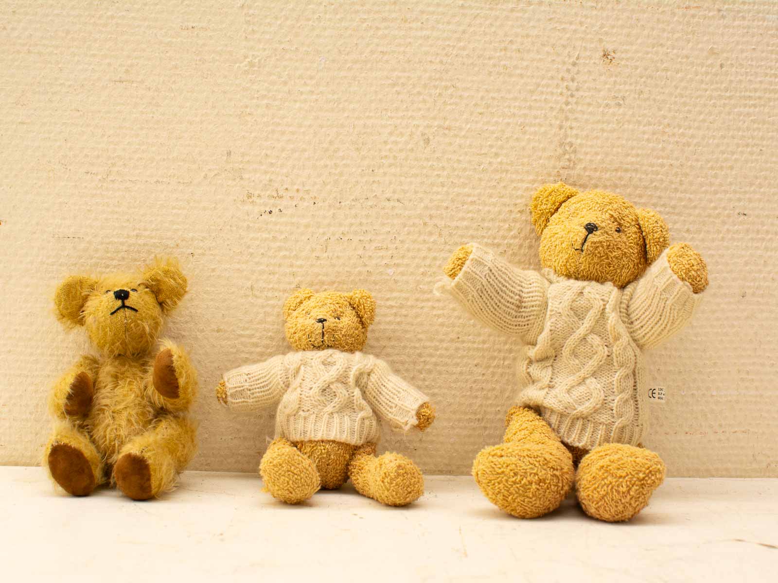 Charming teddy bears in cozy knitwear evoke warmth, nostalgia, and childhood memories.