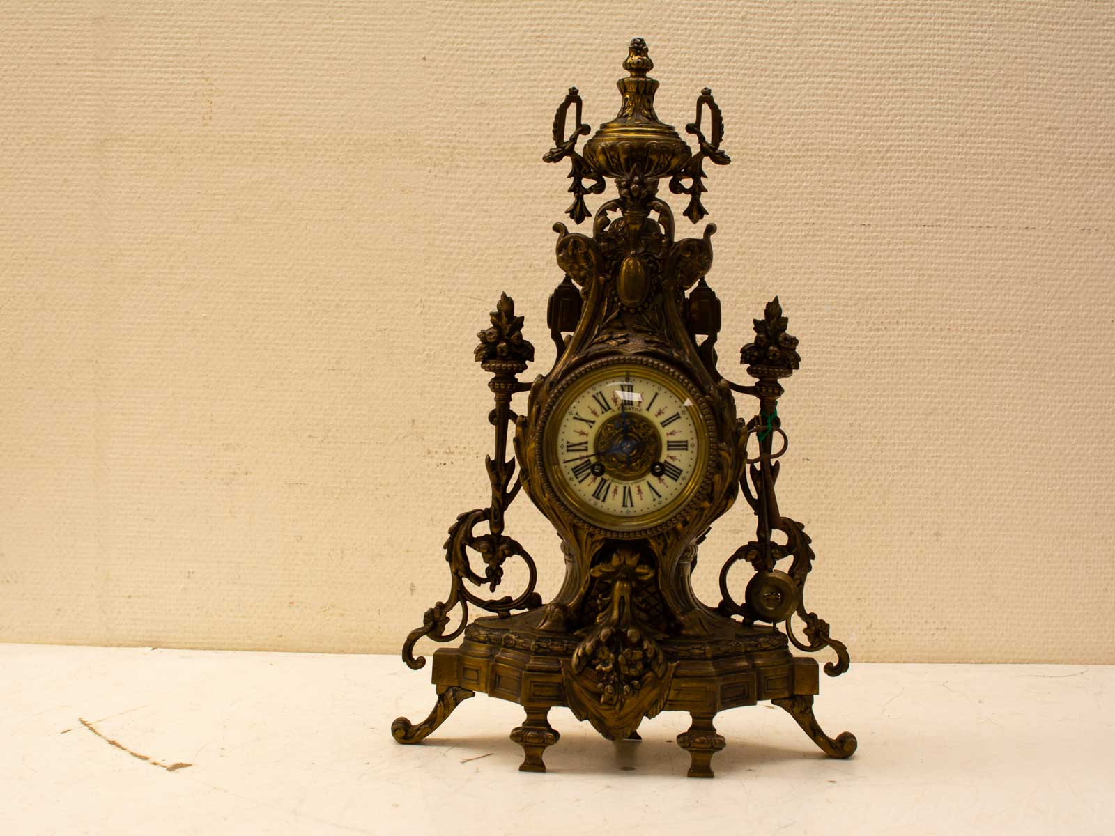 Ornate antique brass clock with floral designs, perfect for vintage home decor elegance.