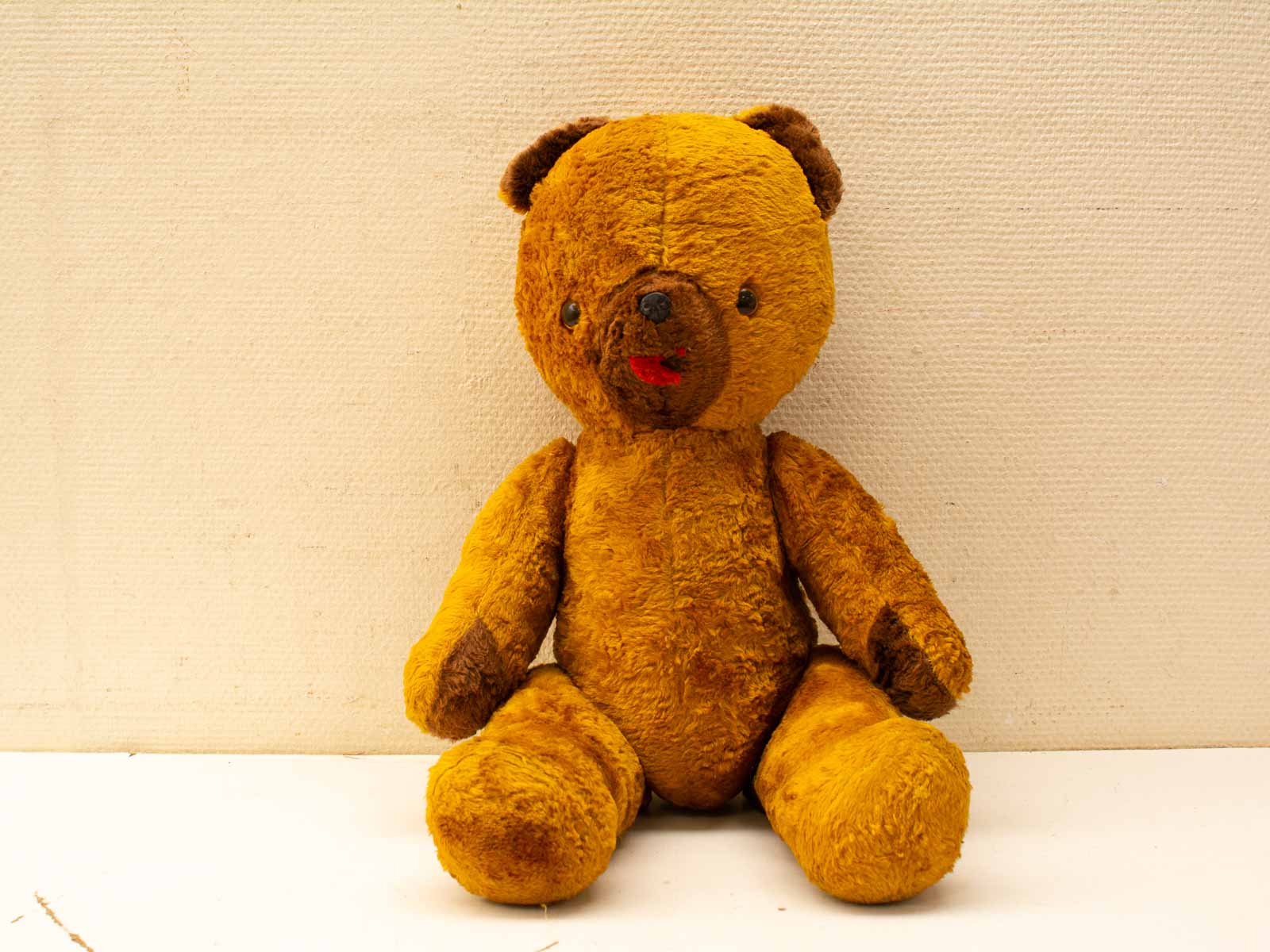 Charming vintage teddy bear, a soft companion with a loving history and playful expression.