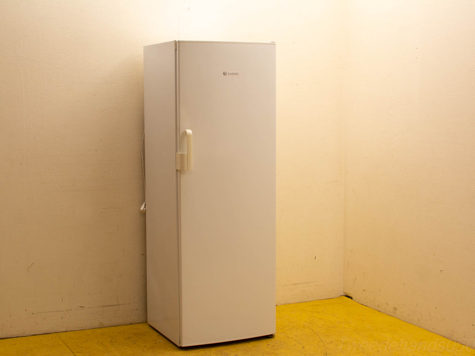 Sleek white refrigerator in corner, blending modern design with everyday functionality for your home.