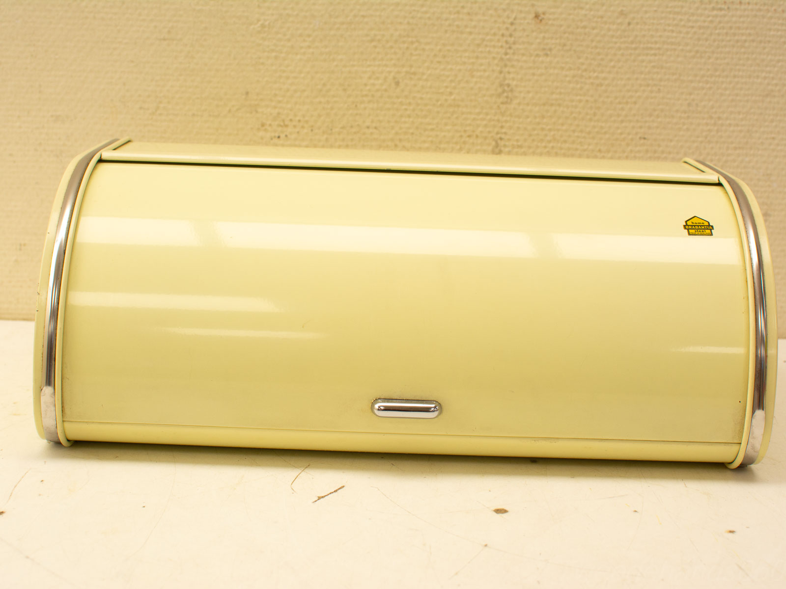 Charming vintage crème yellow bread box with chrome accents, perfect for any kitchen decor.