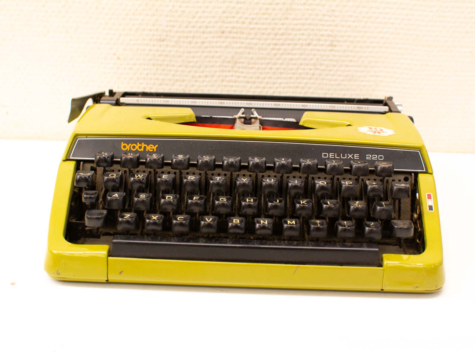 Vintage Brother Deluxe 220 typewriter in vibrant yellow, perfect for writers and collectors.