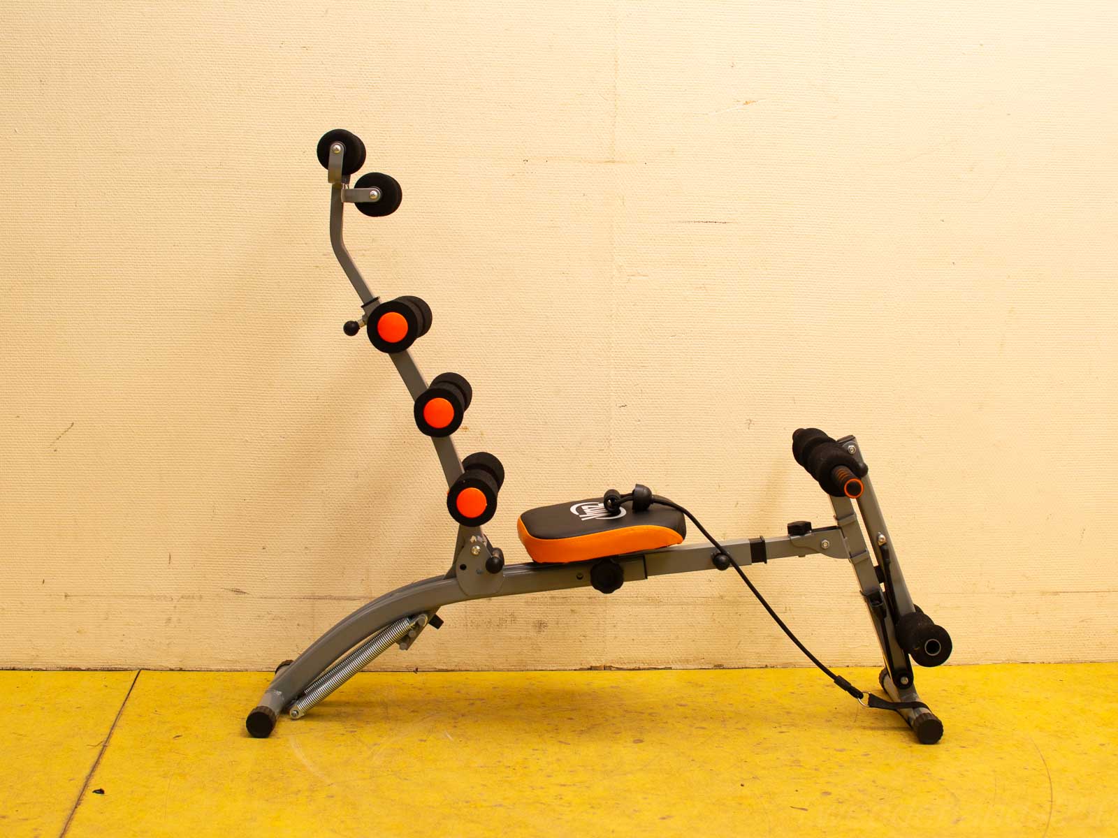 Adjustable fitness bench with padded rollers for home workouts and versatile training options.