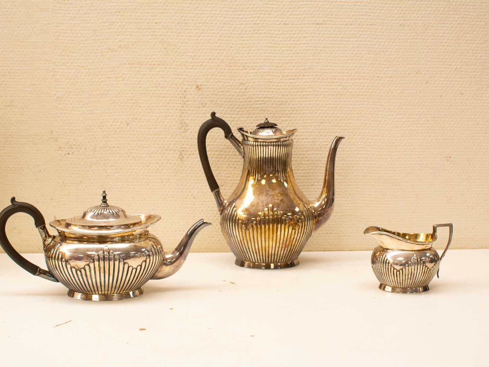 Elegant silver tea service set featuring a teapot, sugar bowl, and creamer for stylish gatherings.