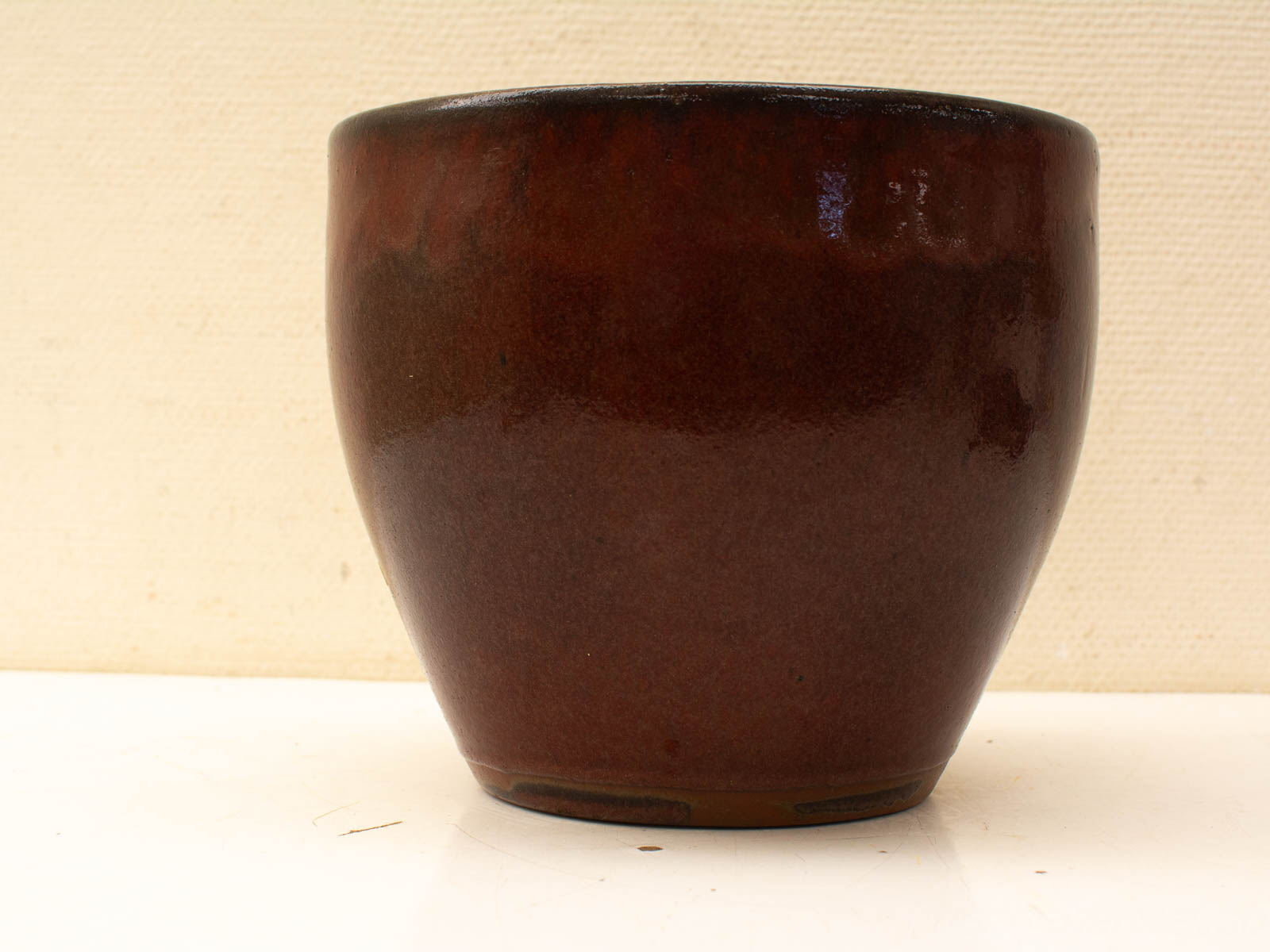 Elegant brown ceramic pot with glossy finish, perfect for decor or versatile storage solutions.