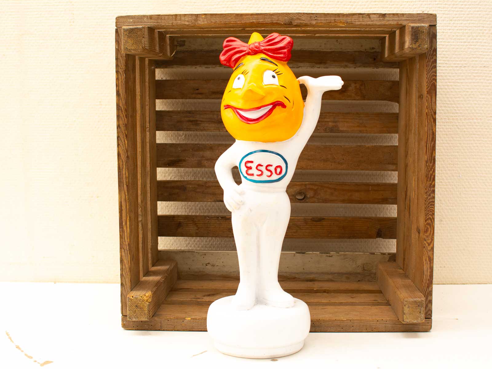 Vintage Esso statuette with cheerful face and red bow, perfect for collectors and nostalgia.