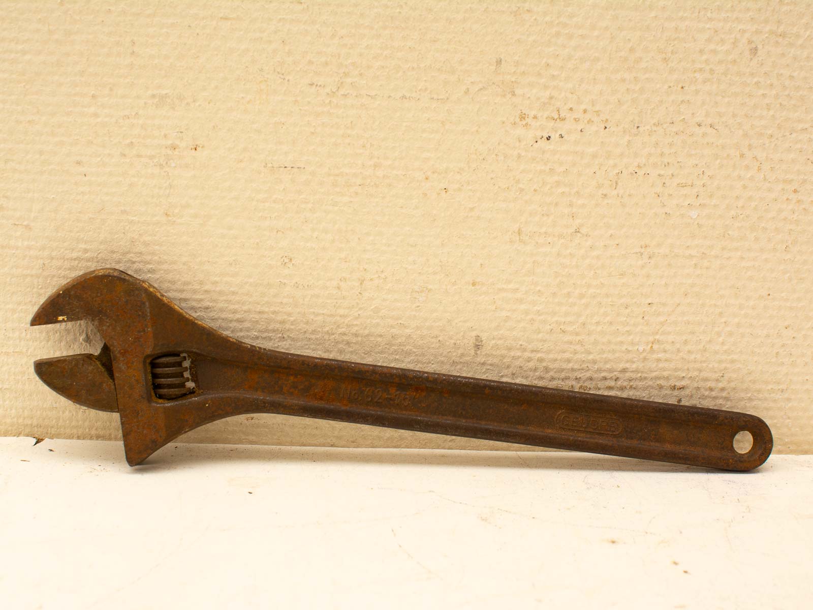 Vintage adjustable wrench with rustic patina, perfect for collectors and DIY enthusiasts.