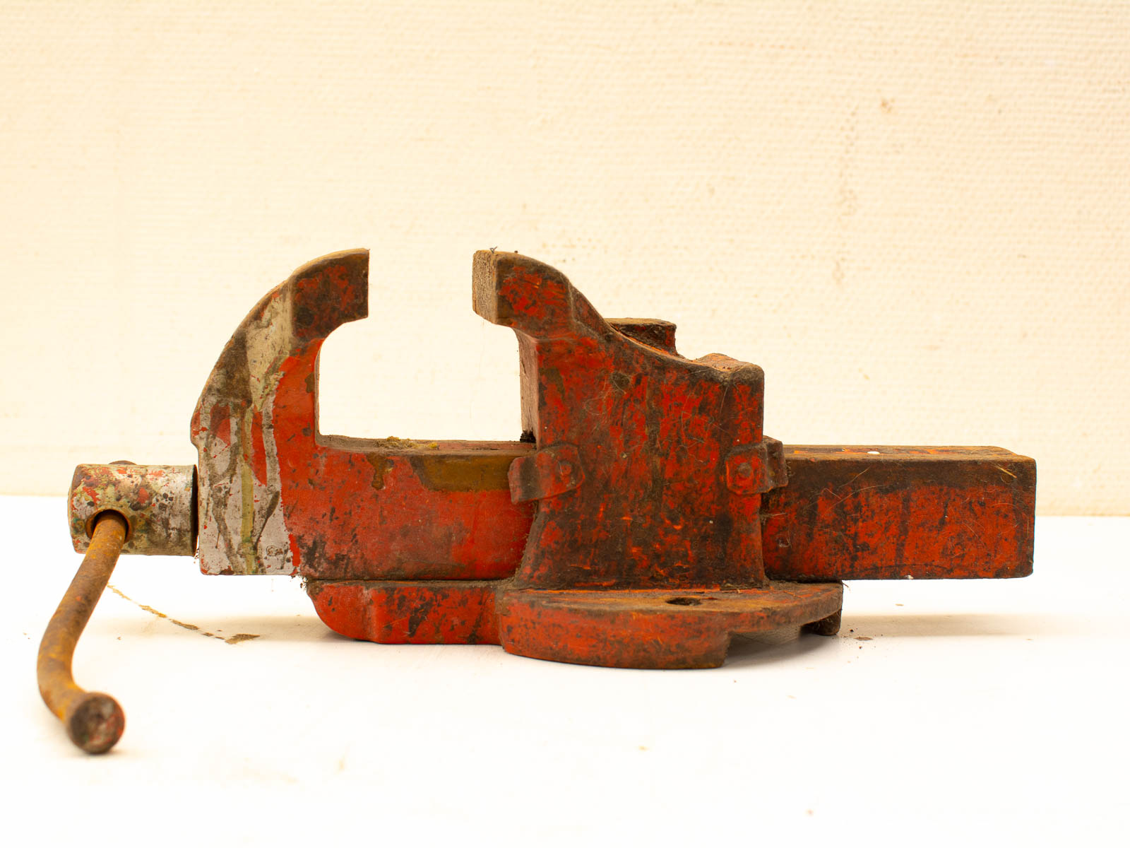 Durable vintage red vise with patina, showcasing wear from years of reliable use.