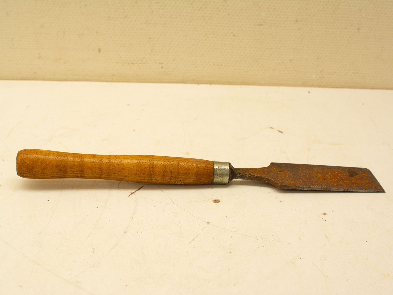 Vintage wooden chisel with ergonomic handle, perfect for woodworking and creative projects.