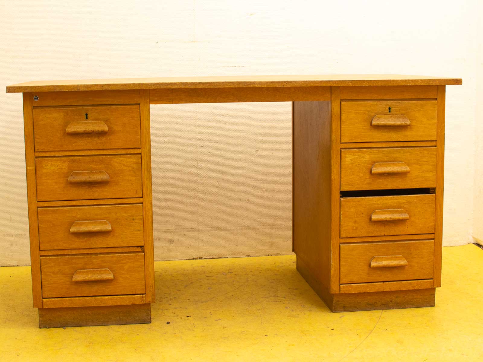 Stylish honey-hued wooden desk with six drawers for a functional and elegant workspace.