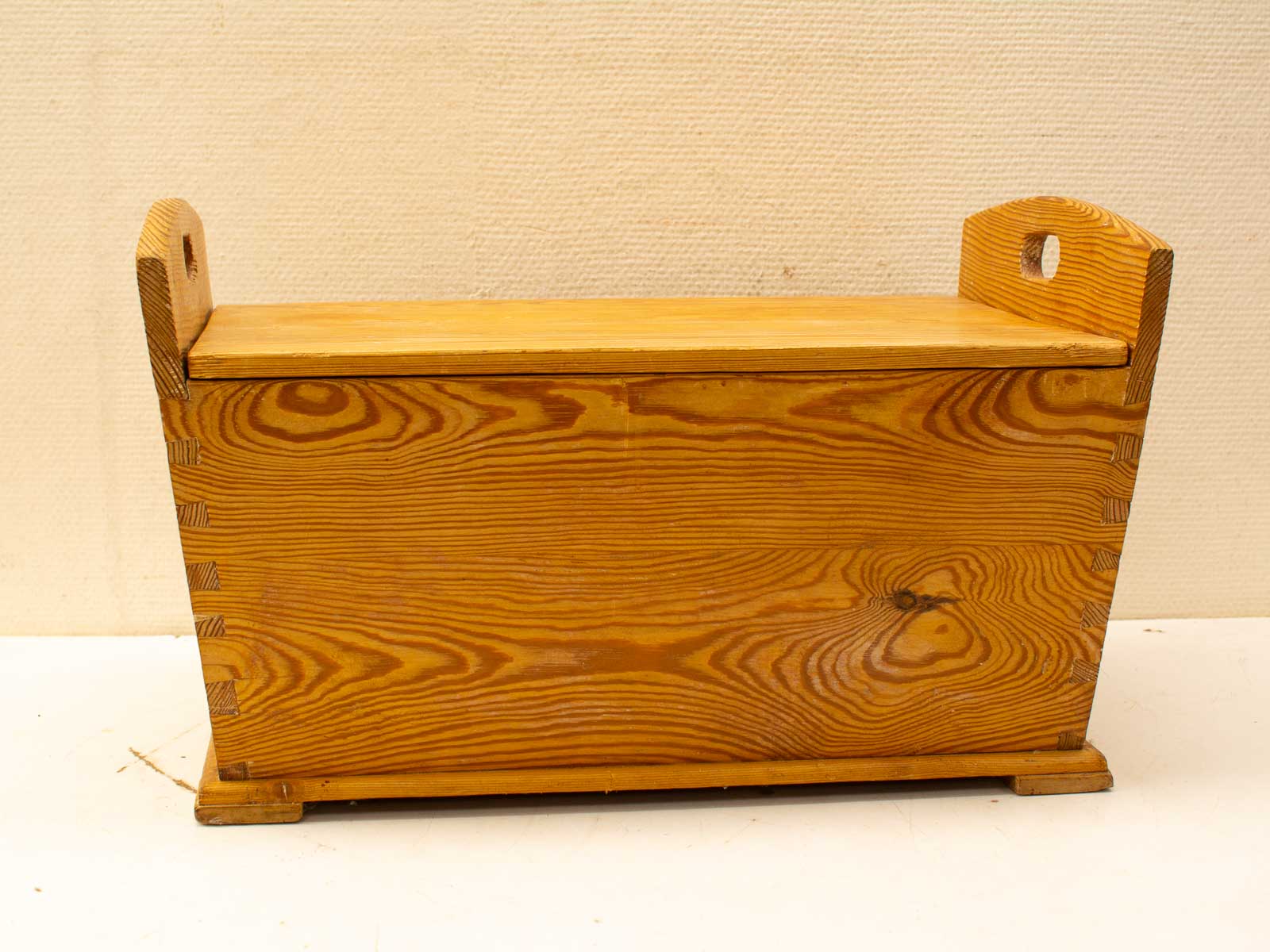 Handcrafted wooden storage box with rustic charm and elegant dovetail joints for stylish organization.