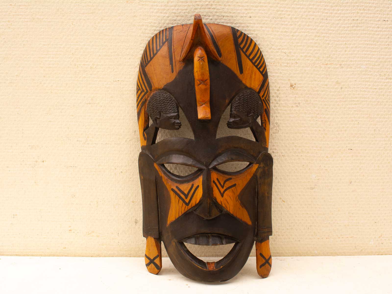 Exquisite wooden mask with intricate carvings and geometric patterns, ideal for cultural celebrations.