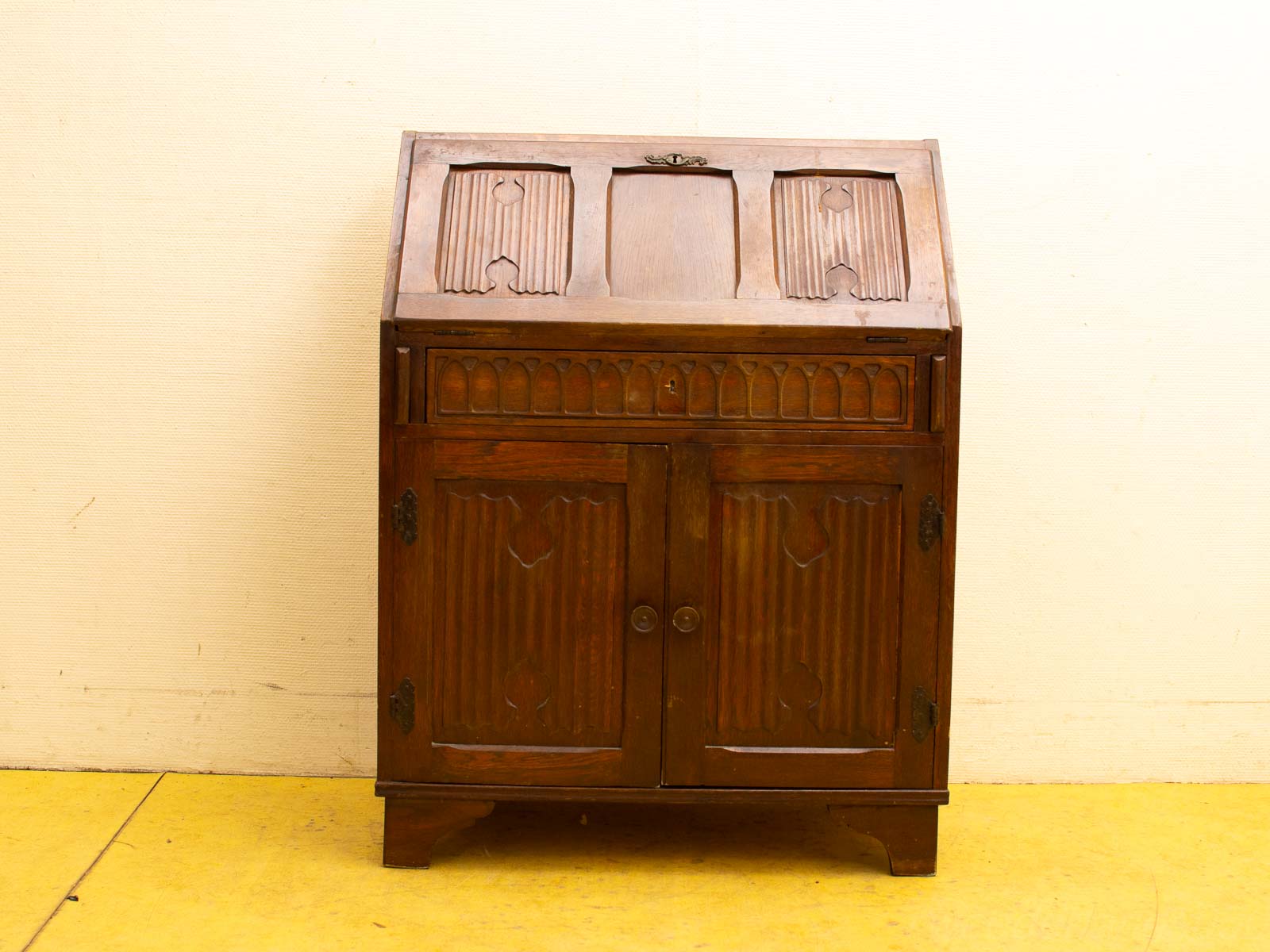 Elegant vintage wooden cabinet with intricate carvings and ribbed patterns for stylish storage.