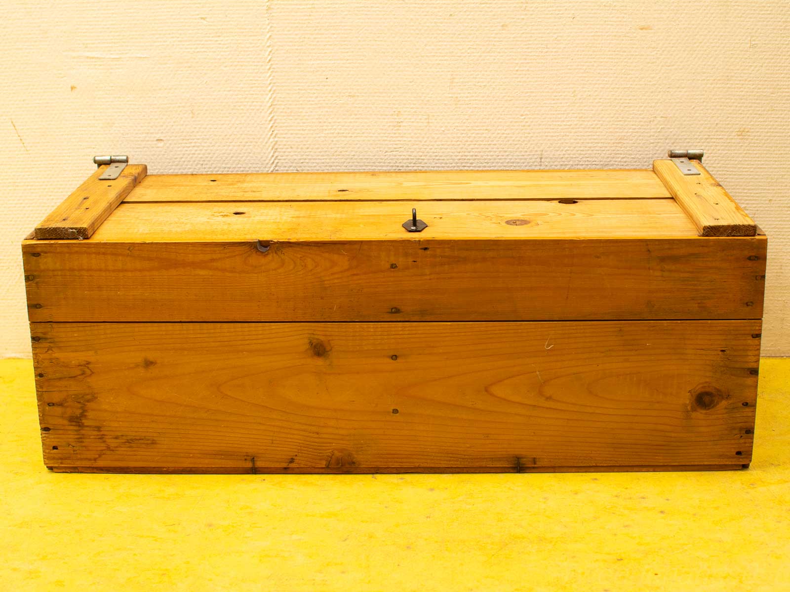 Rustic wooden storage box with metal hinges, perfect for organization and timeless charm.