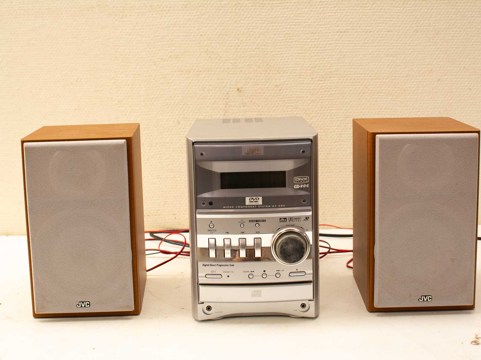 Compact JVC audio system with stylish wooden speakers for exceptional sound in any home.