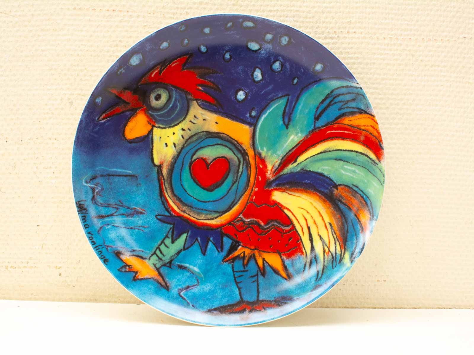 Vibrant hand-painted ceramic plate featuring a whimsical rooster design for decor or functionality.