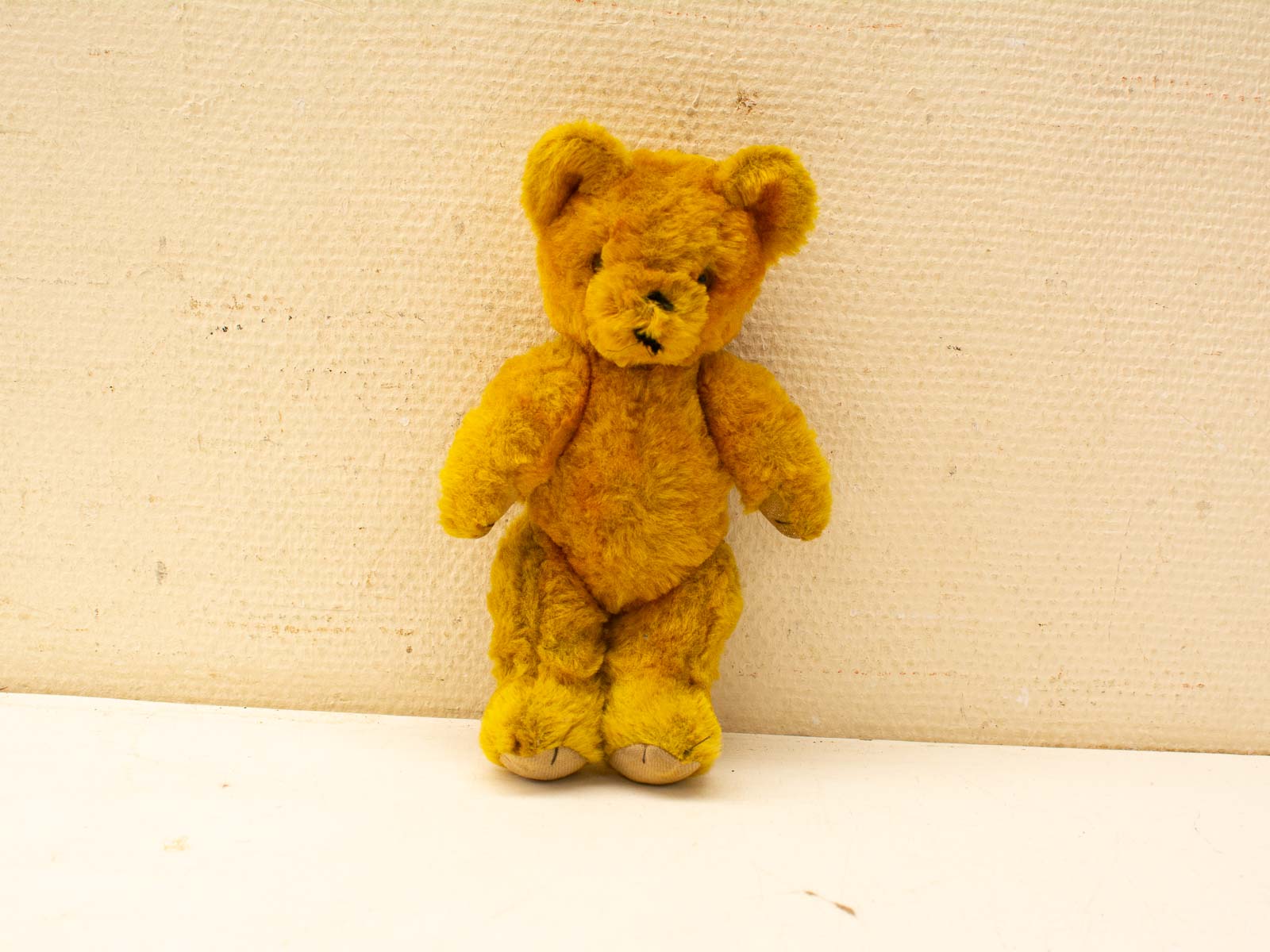 Charming vintage yellow teddy bear, perfect for nostalgia and cozy companionship.