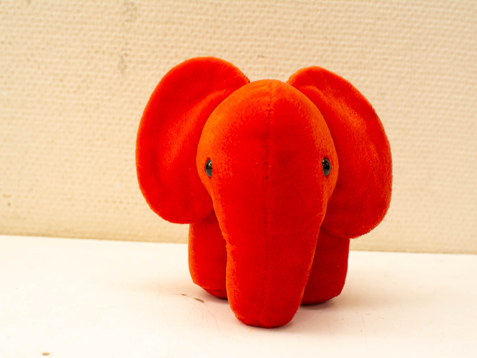 Bright orange elephant plush toy, perfect for cuddles and joy for all ages.