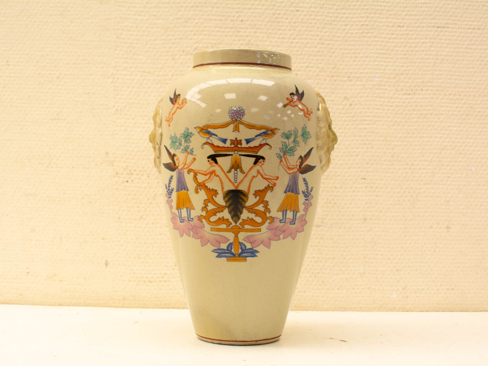 Colorful vintage vase with playful human figures and floral designs, perfect for home decor.