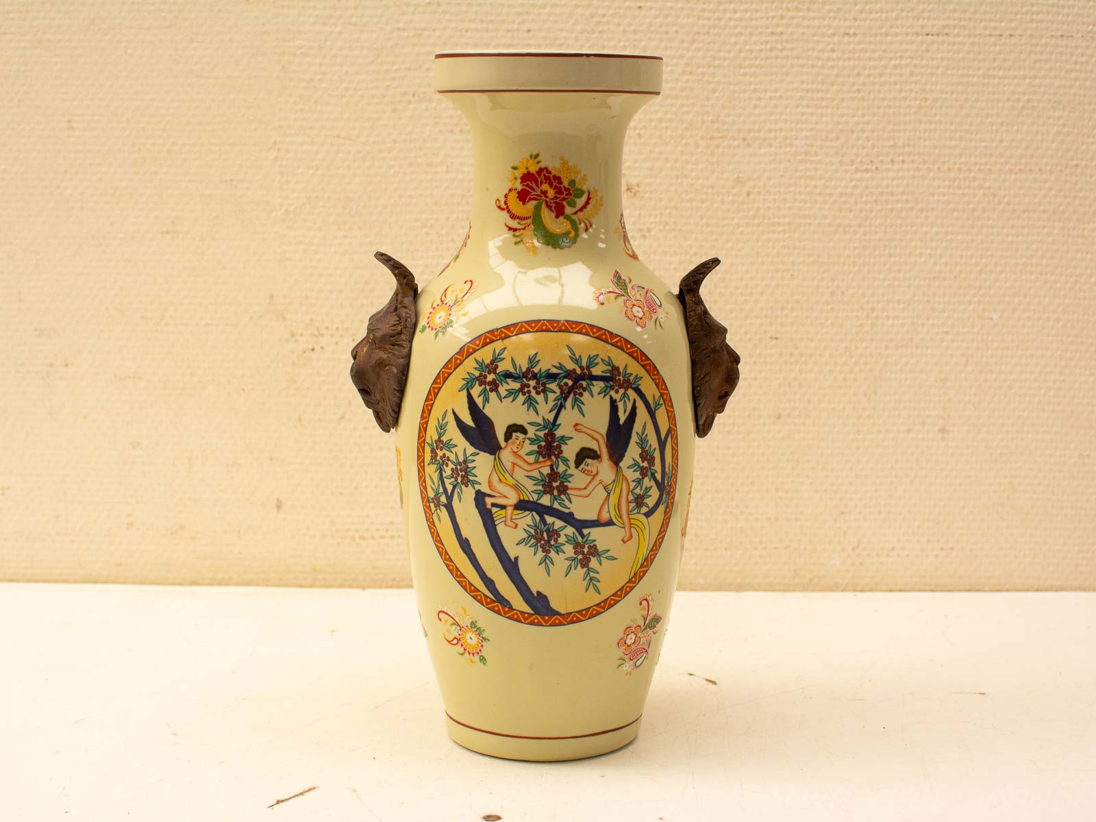 Unique vintage vase with sculptural animal handles and playful decorative scene. Perfect for home decor.