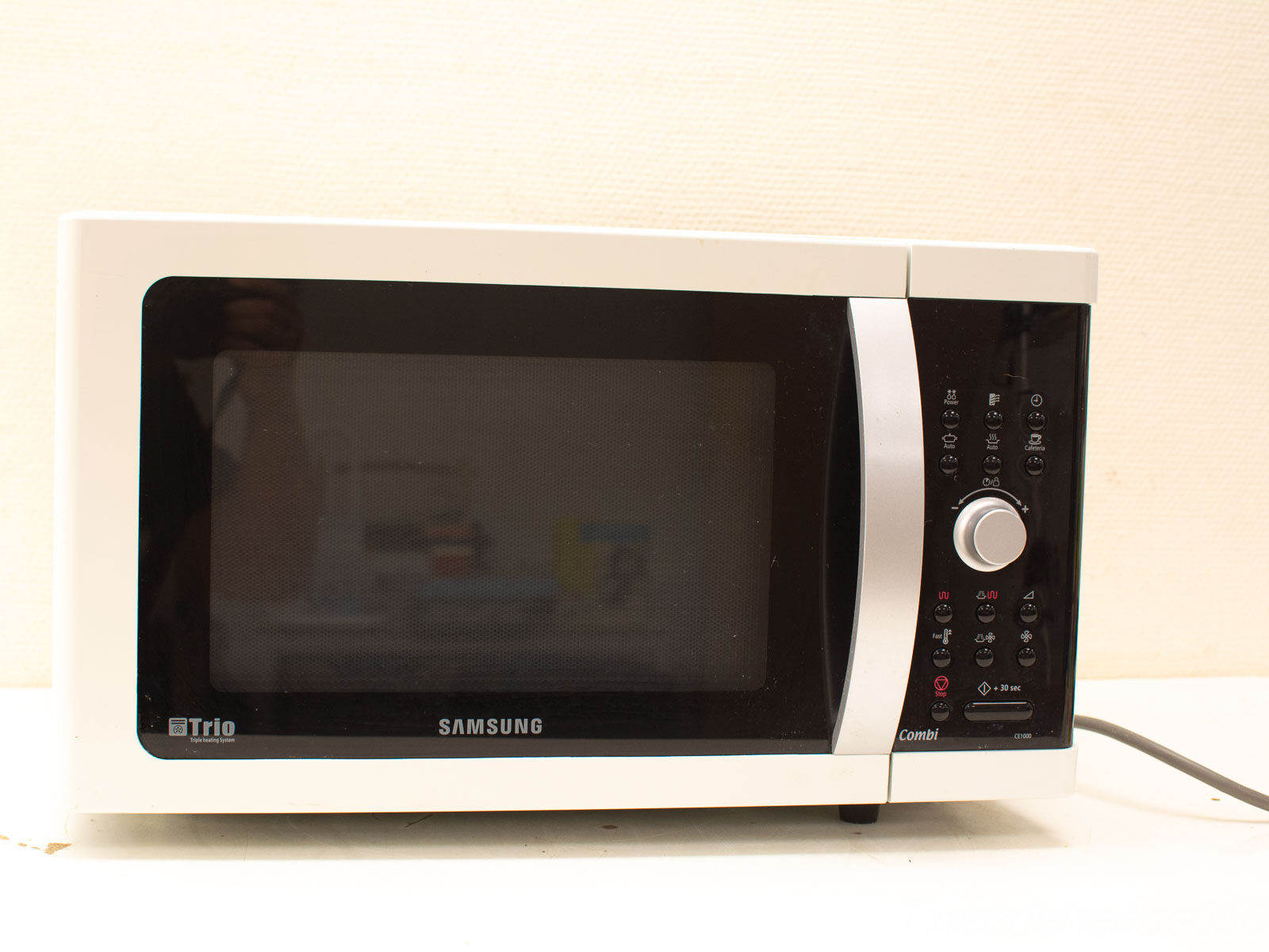 Sleek white Samsung microwave with intuitive controls and elegant black glass panel for modern kitchens.