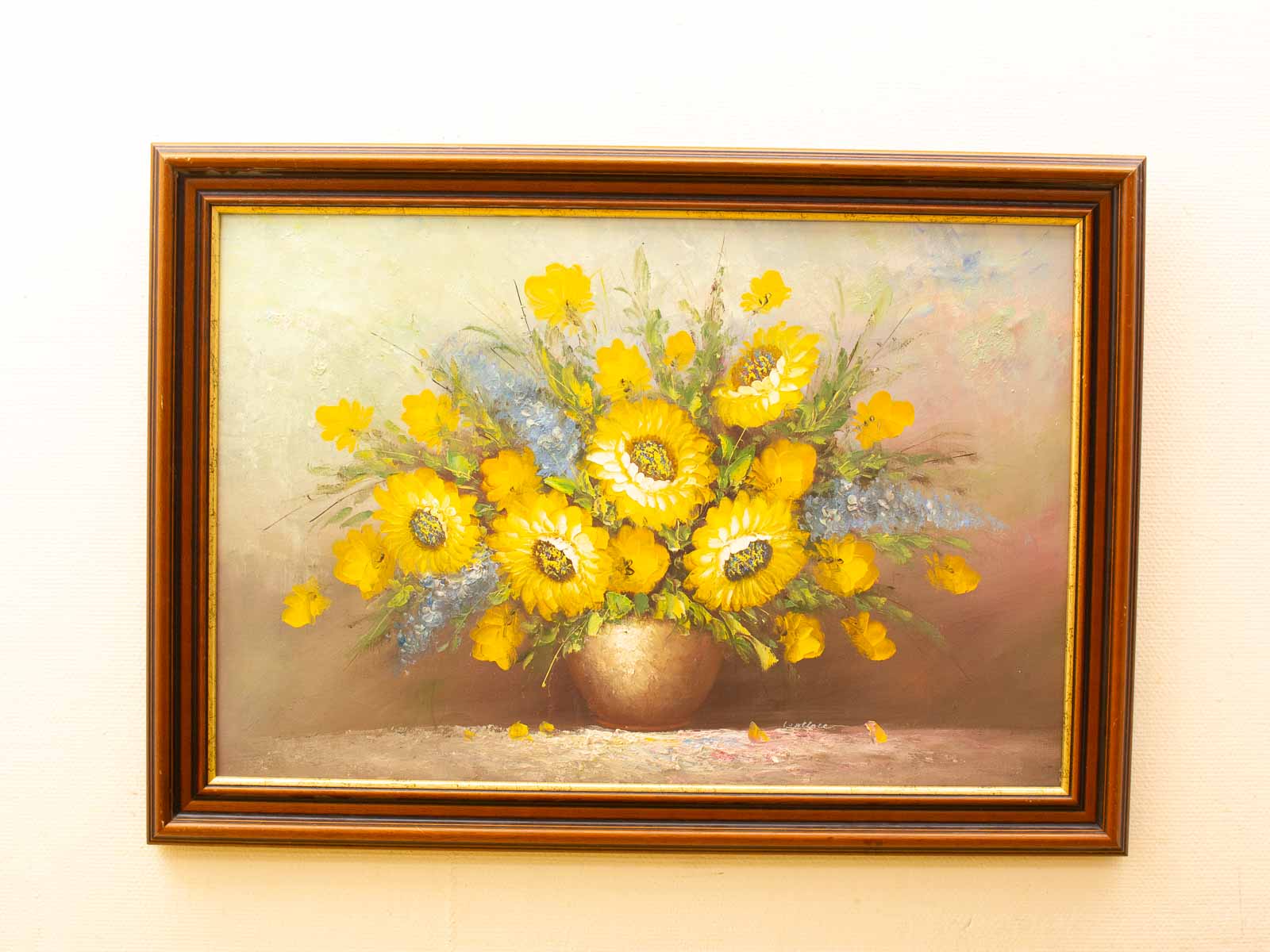 Vibrant still life of sunflowers and delicate blue flowers in an elegant vase.