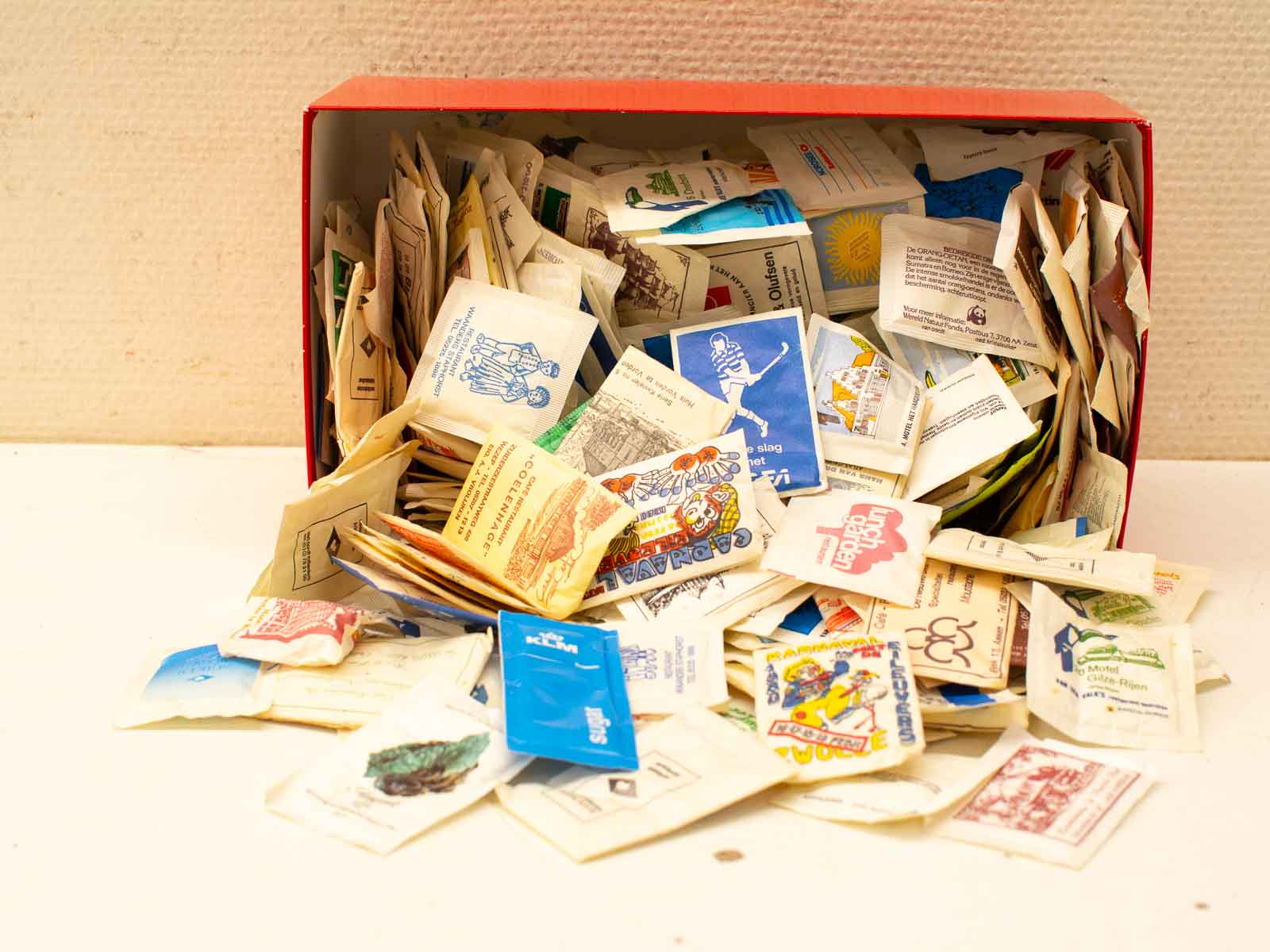 Vibrant seed packets spilling from a colorful box, inviting exploration and gardening possibilities.