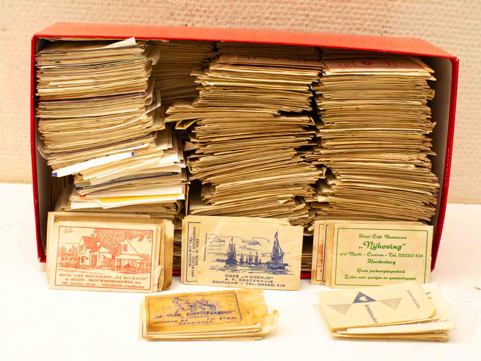 Vintage business cards in a red box evoke nostalgia and local history.