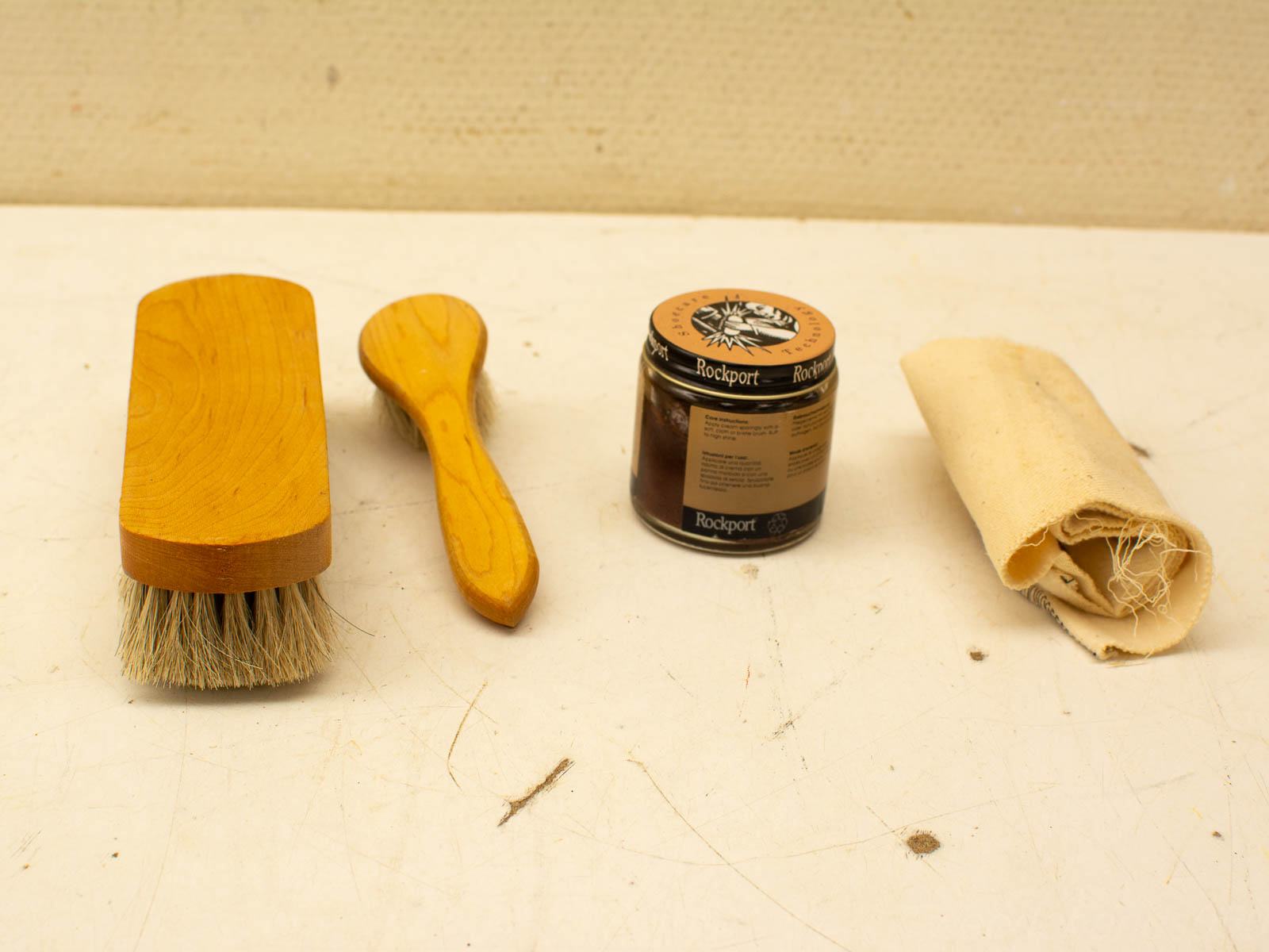 Premium shoe care kit: brushes, polish, and cloth for vintage shoe maintenance.