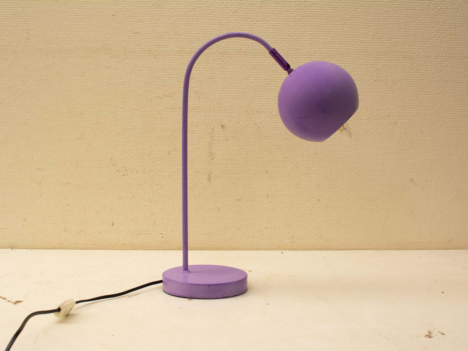 Modern purple table lamp with a playful design, adjustable shade, and vibrant aesthetic.