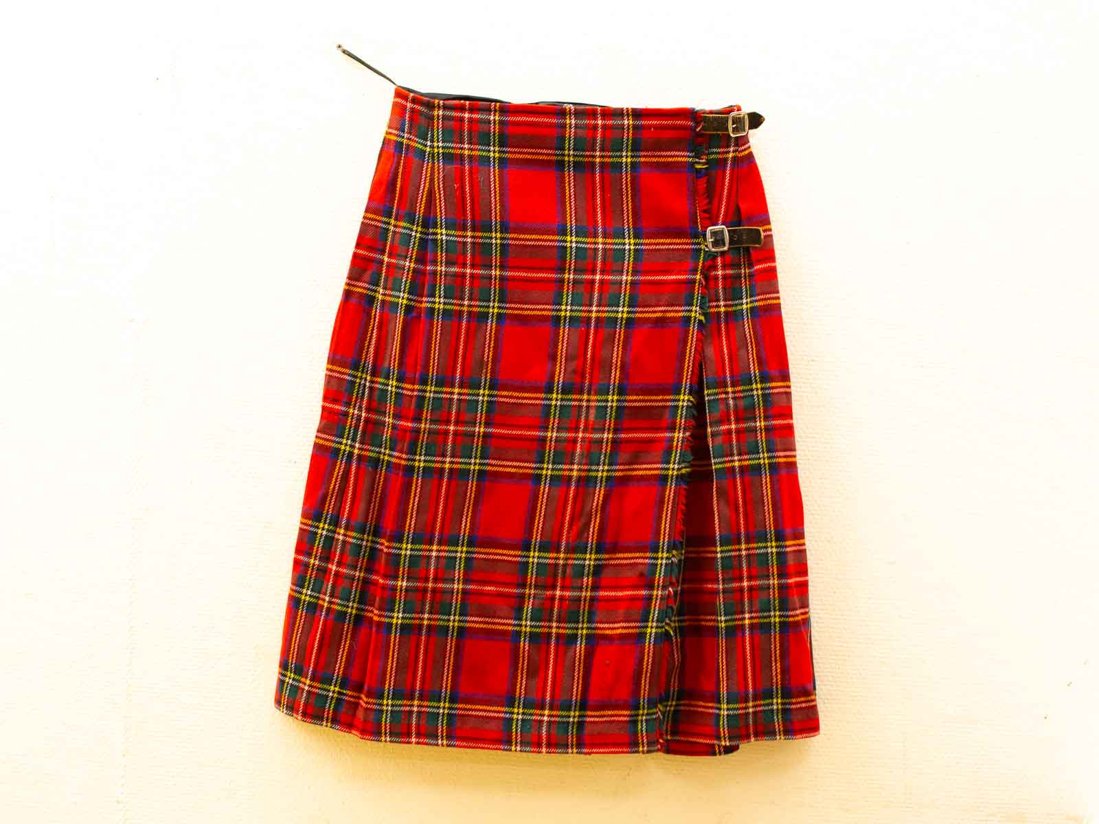 Elegant red tartan skirt with green and yellow accents, ideal for any occasion.