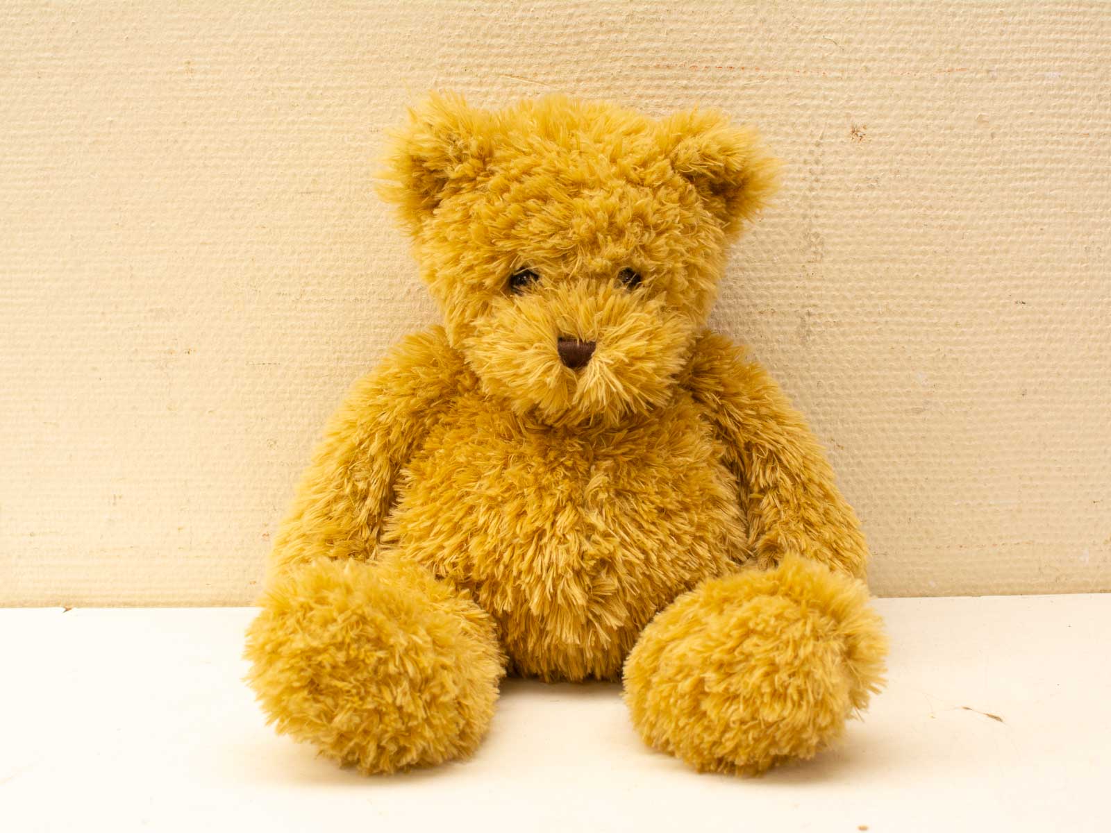 Charming golden teddy bear, vintage plush toy, perfect for hugs and nostalgic decor.