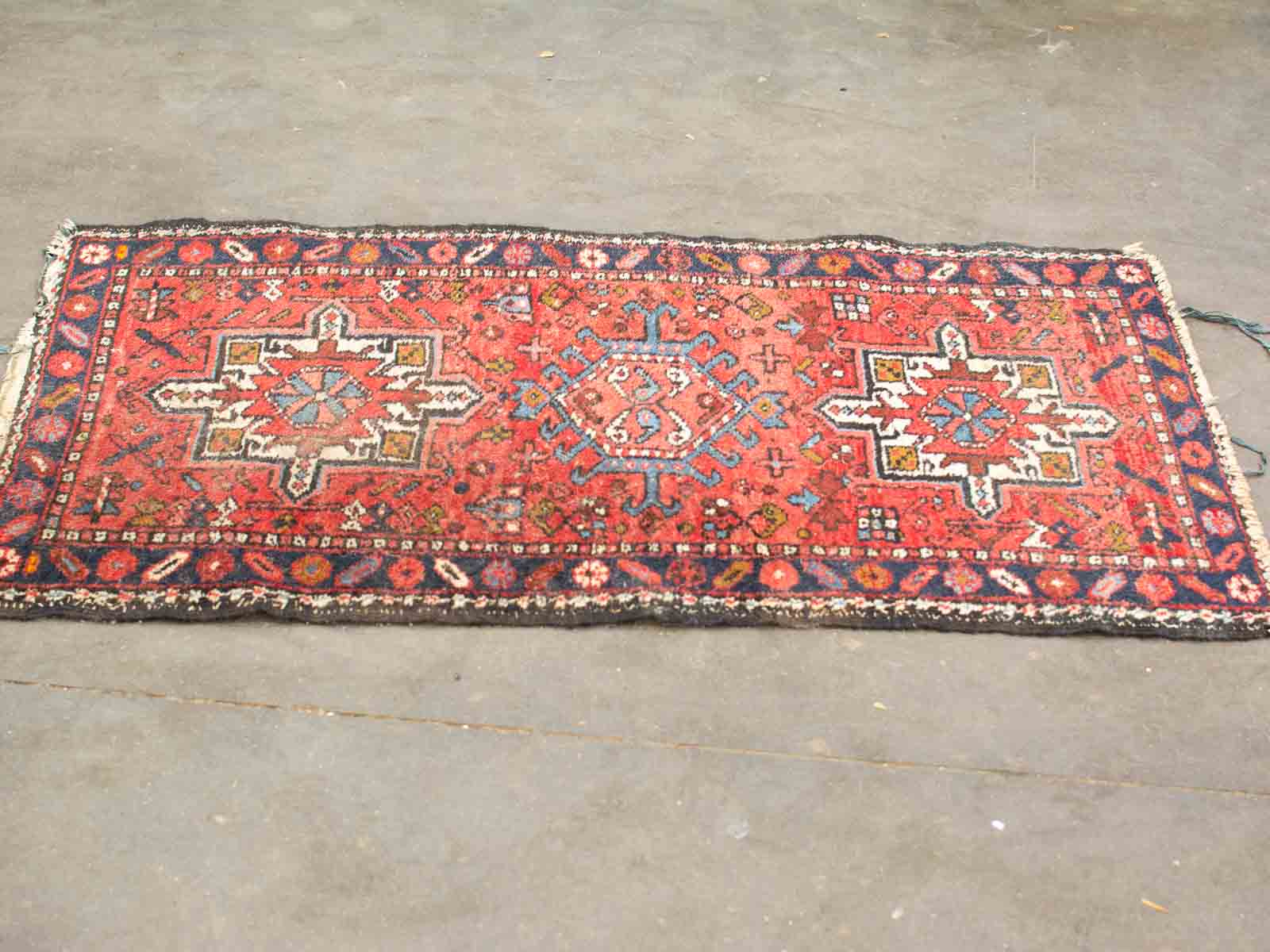 Vibrant red traditional rug with intricate geometric patterns and star motifs for a charming space.