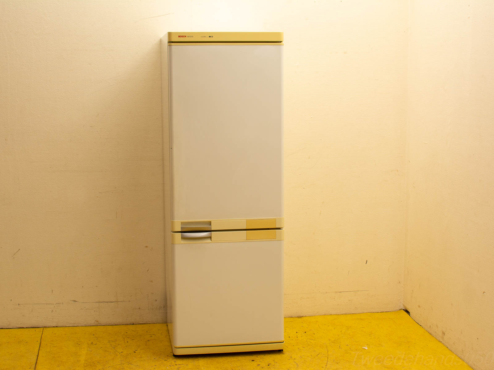 Vintage Bosch refrigerator in white and beige, perfect for small to medium kitchens.