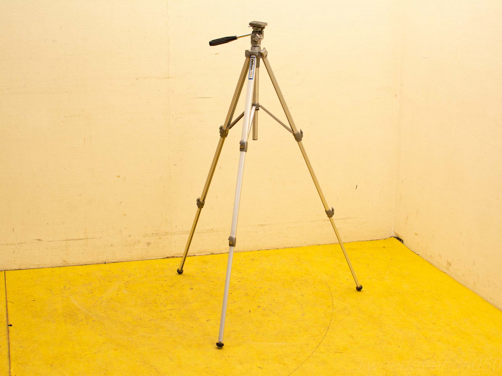 Vintage tripod in a cozy room, ideal for creative photography shoots and stable support.