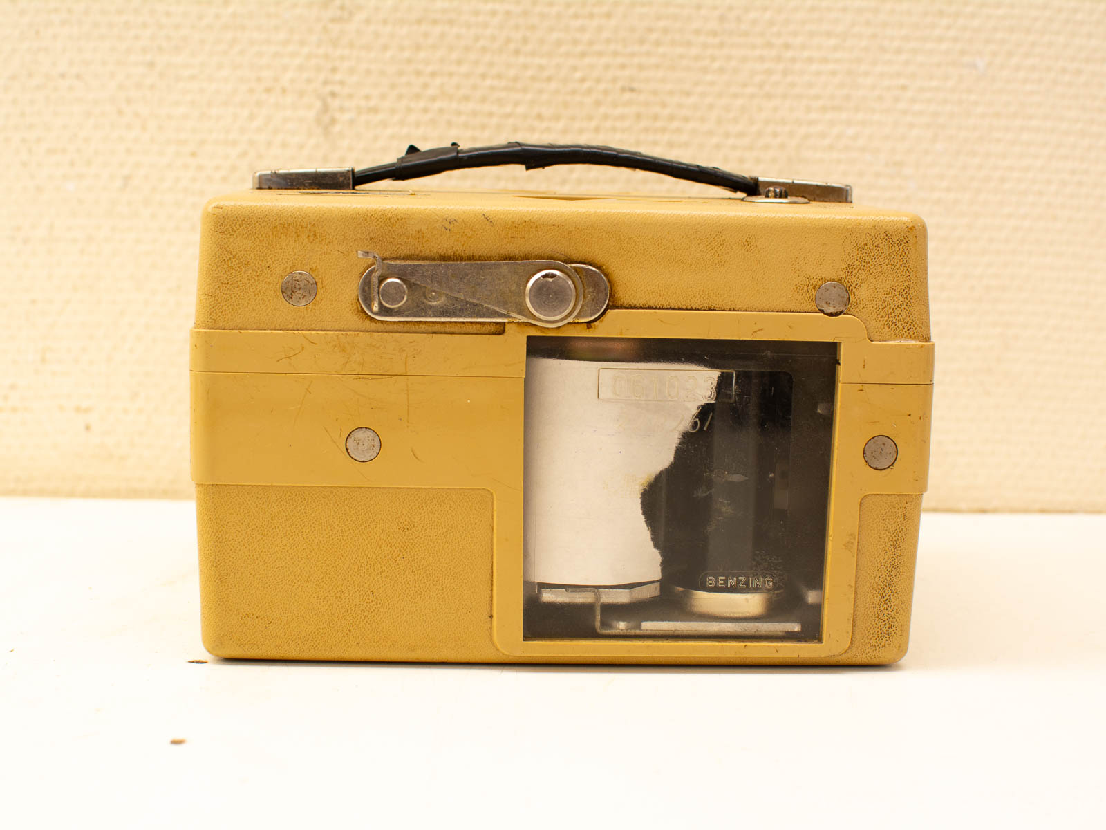 Vintage yellow camera with transparent design, showcasing nostalgia and classic photography craftsmanship.