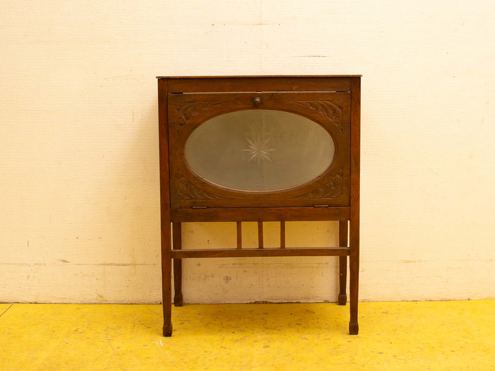 Elegant vintage wooden cabinet with oval glass door, perfect for displaying collectibles and enhancing decor.