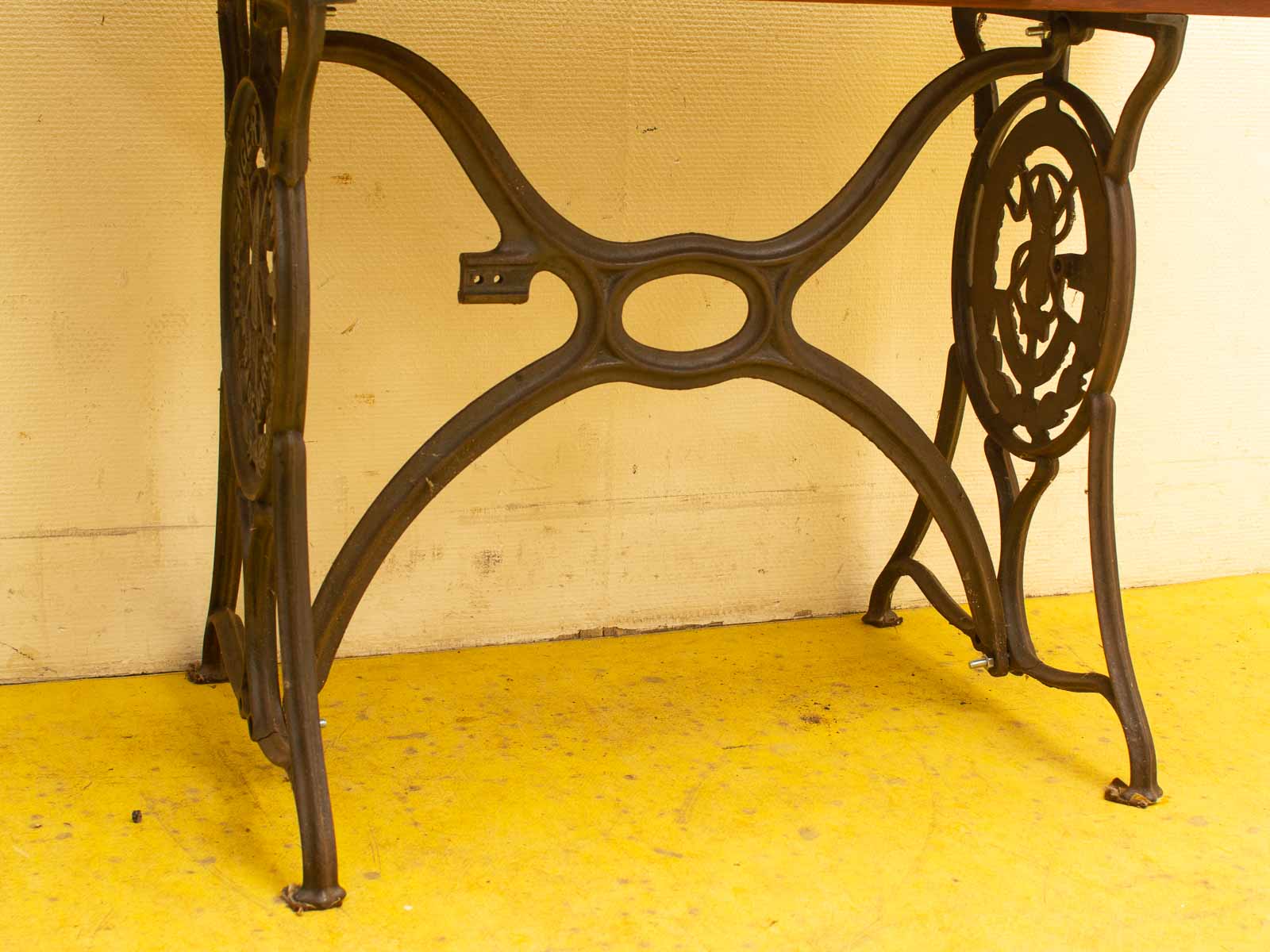 Intricate vintage wrought iron table base with floral design, perfect for classic interiors.