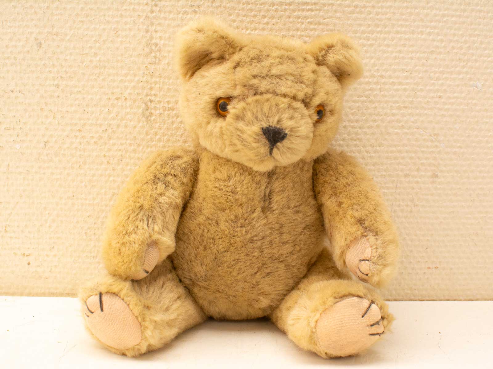 Charming vintage teddy bear with soft, warm brown fur and endearing amber eyes. Perfect gift!