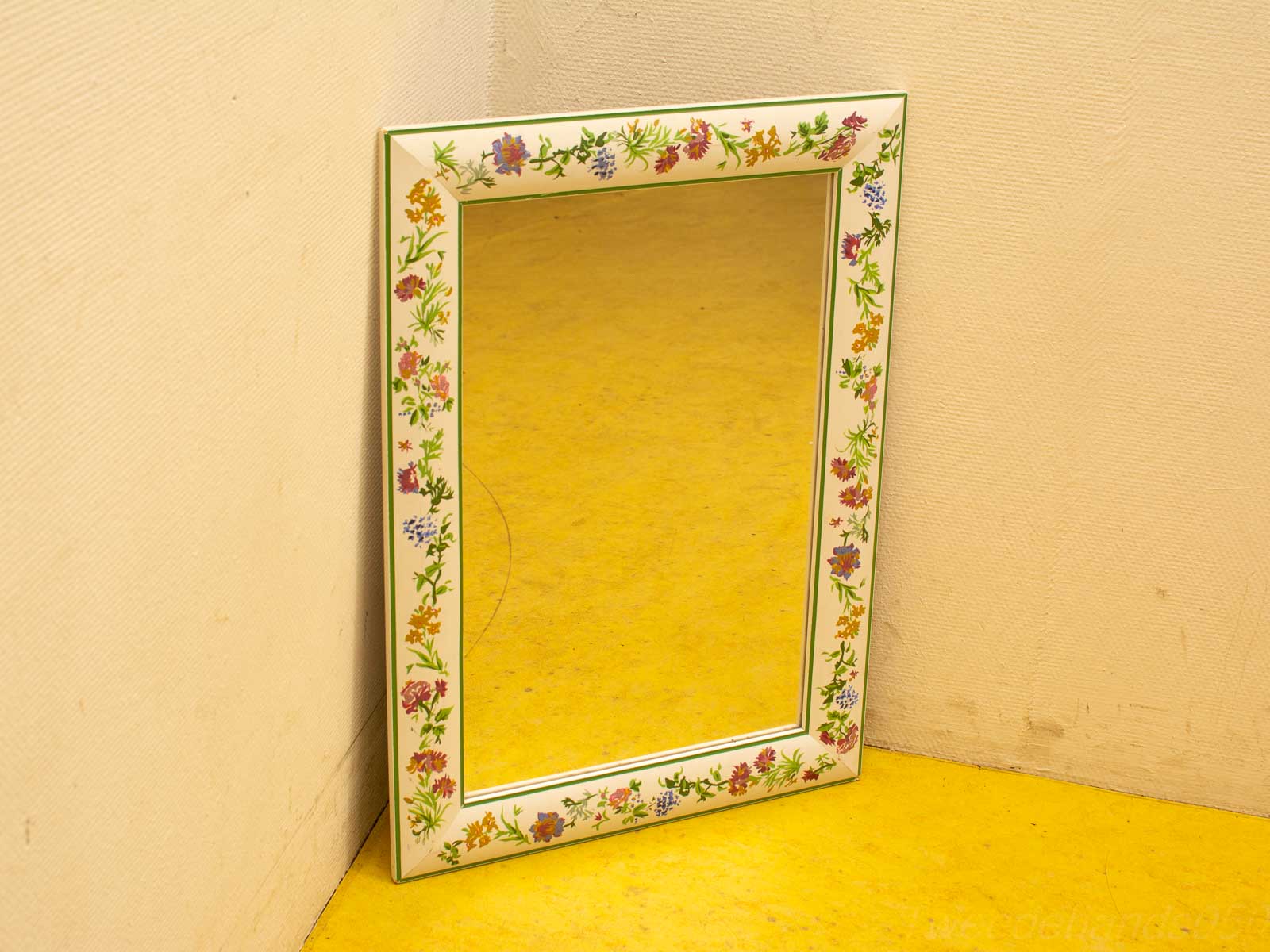 Vibrant vintage mirror with floral frame brightening your space with color and charm.